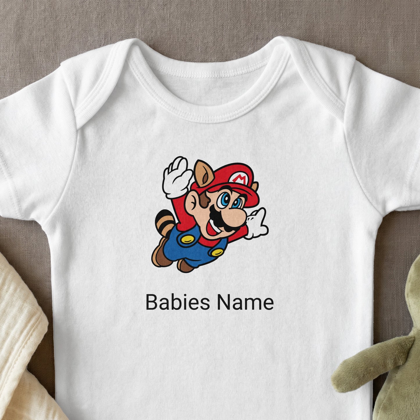 White baby onesie with Mario character and customizable name.
