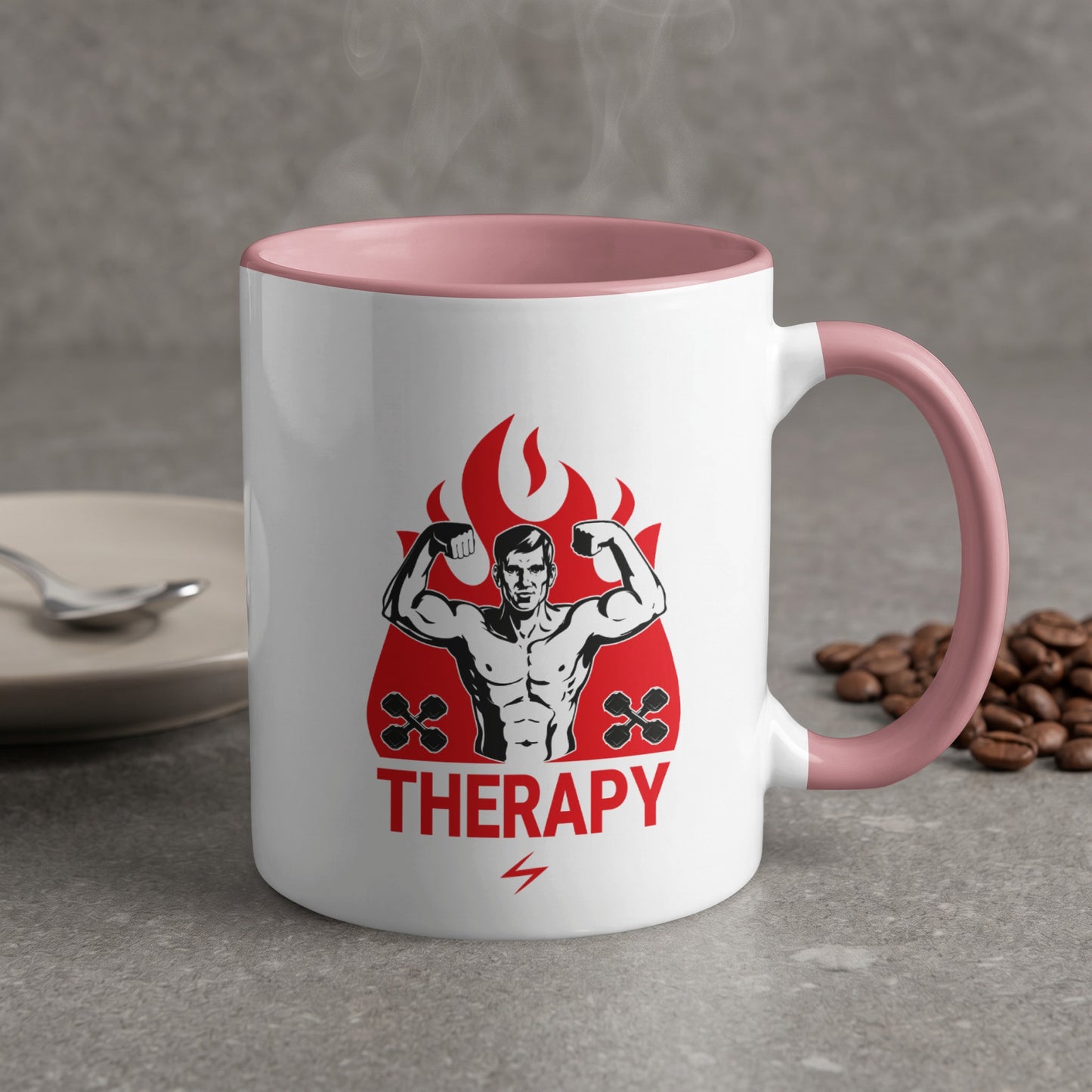 White mug with pink rim featuring muscular man flexing, fire, and the word THERAPY.