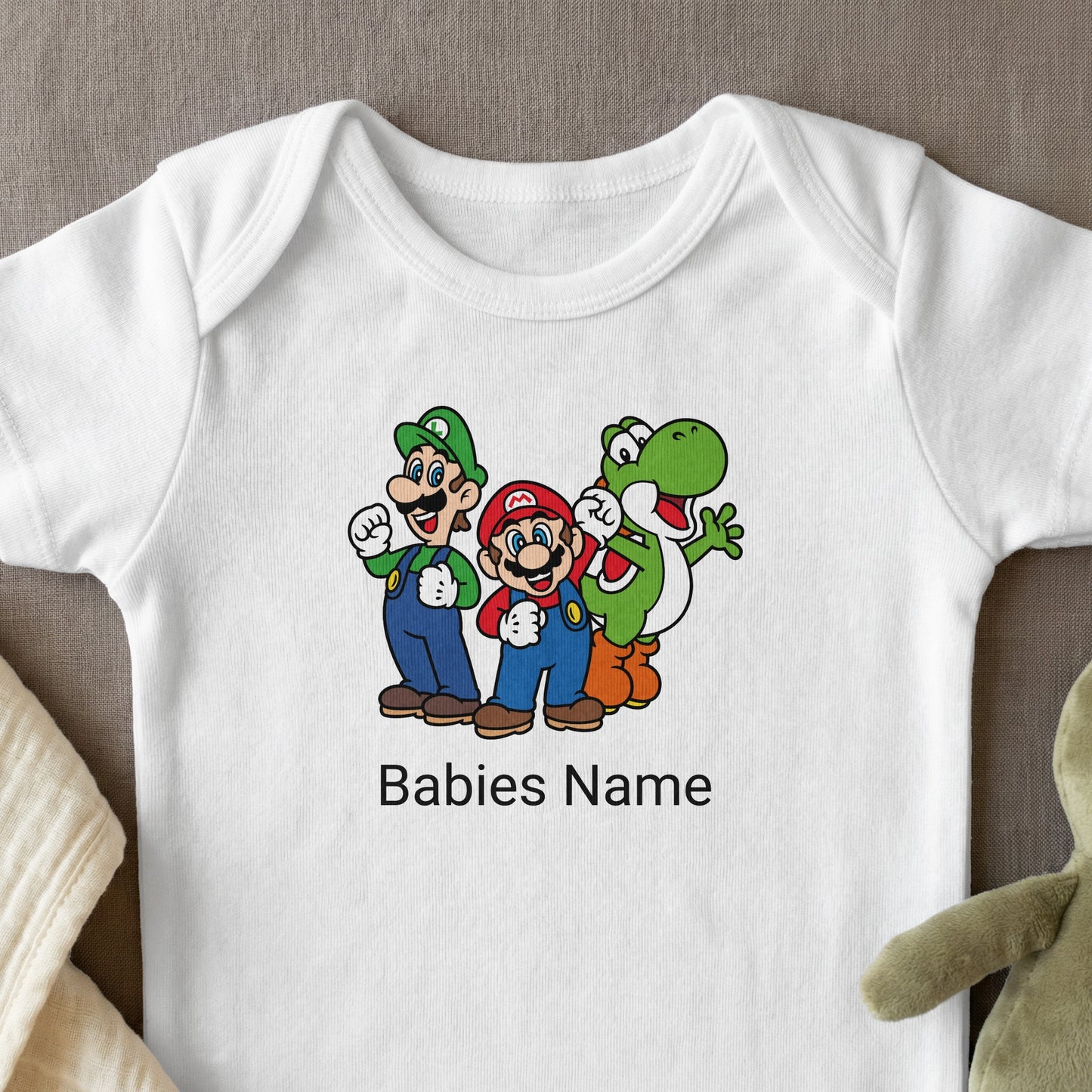 Mario, Luigi, and Yoshi characters with "Babies Name" text on a white baby bodysuit.