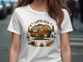 White t-shirt with leopard print camper, campfire, flowers, and text "Camping Queen".