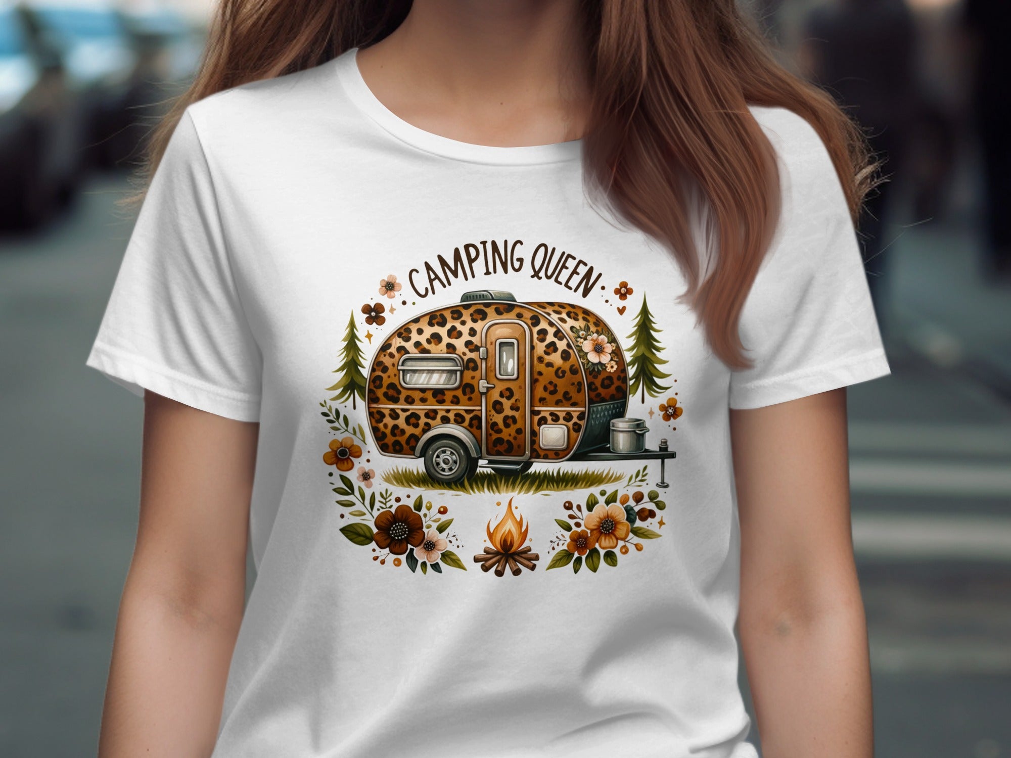 White t-shirt with leopard print camper, campfire, flowers, and text "Camping Queen".