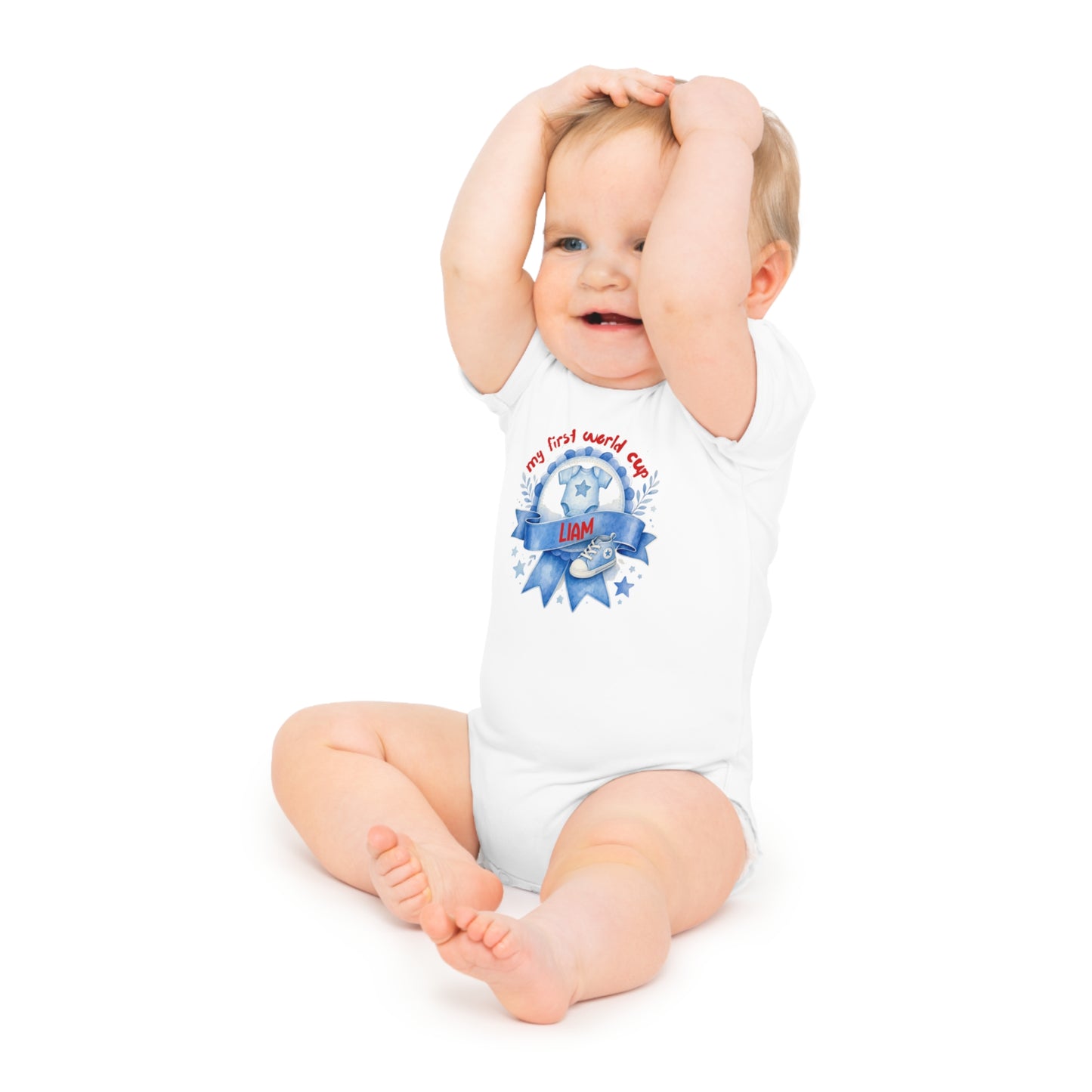 Baby wearing a white bodysuit that says "my first world cup" and "LIAM".
