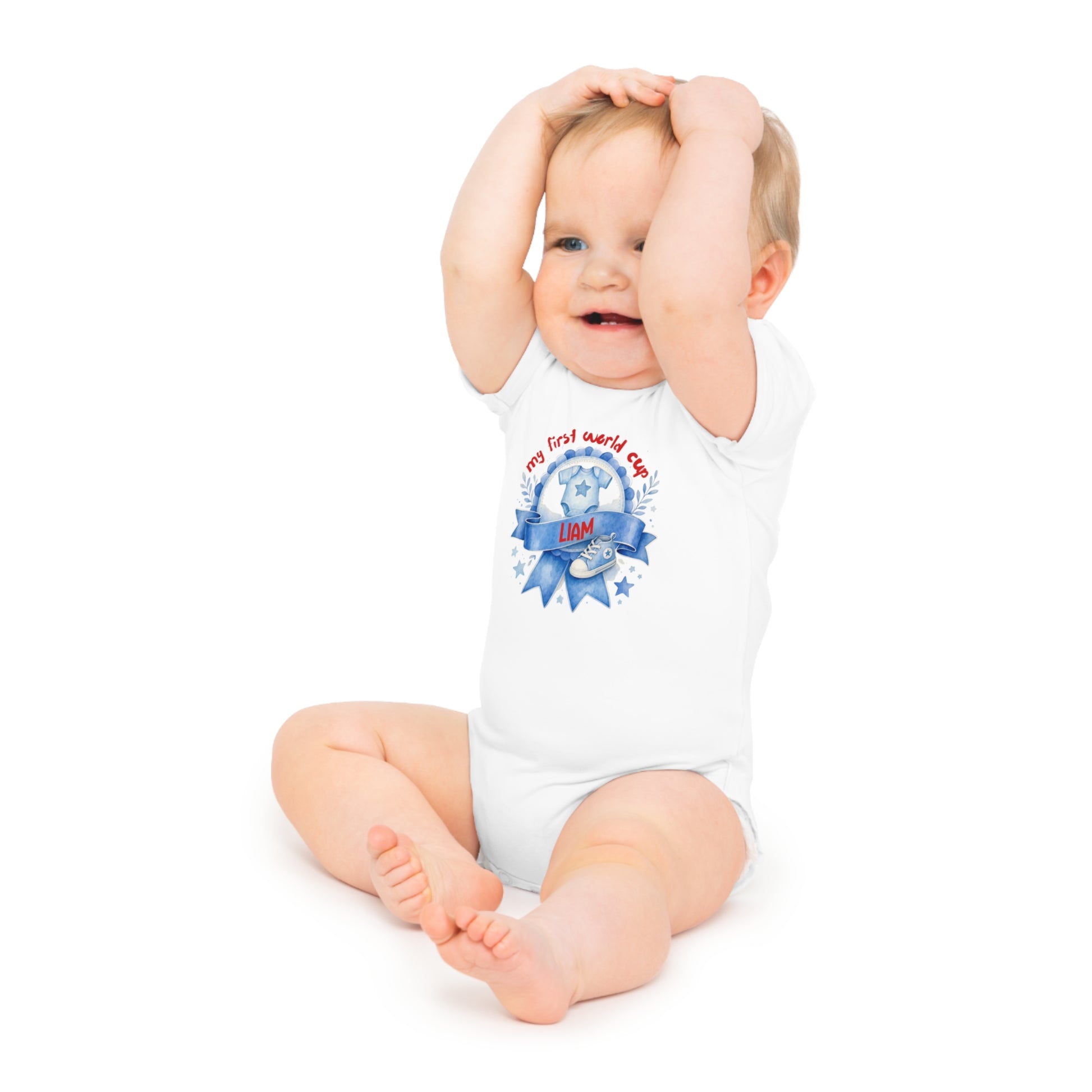 Baby wearing a white bodysuit that says "my first world cup" and "LIAM".