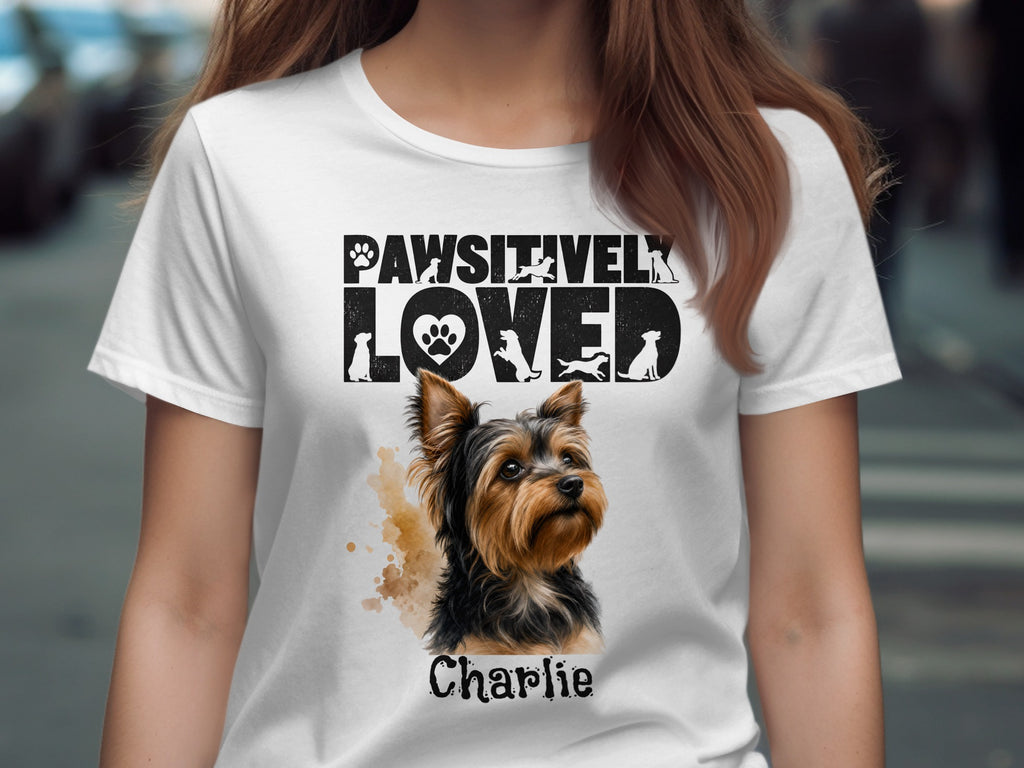 White t-shirt with "Pawsitively Loved" text, a Yorkshire terrier, and "Charlie."