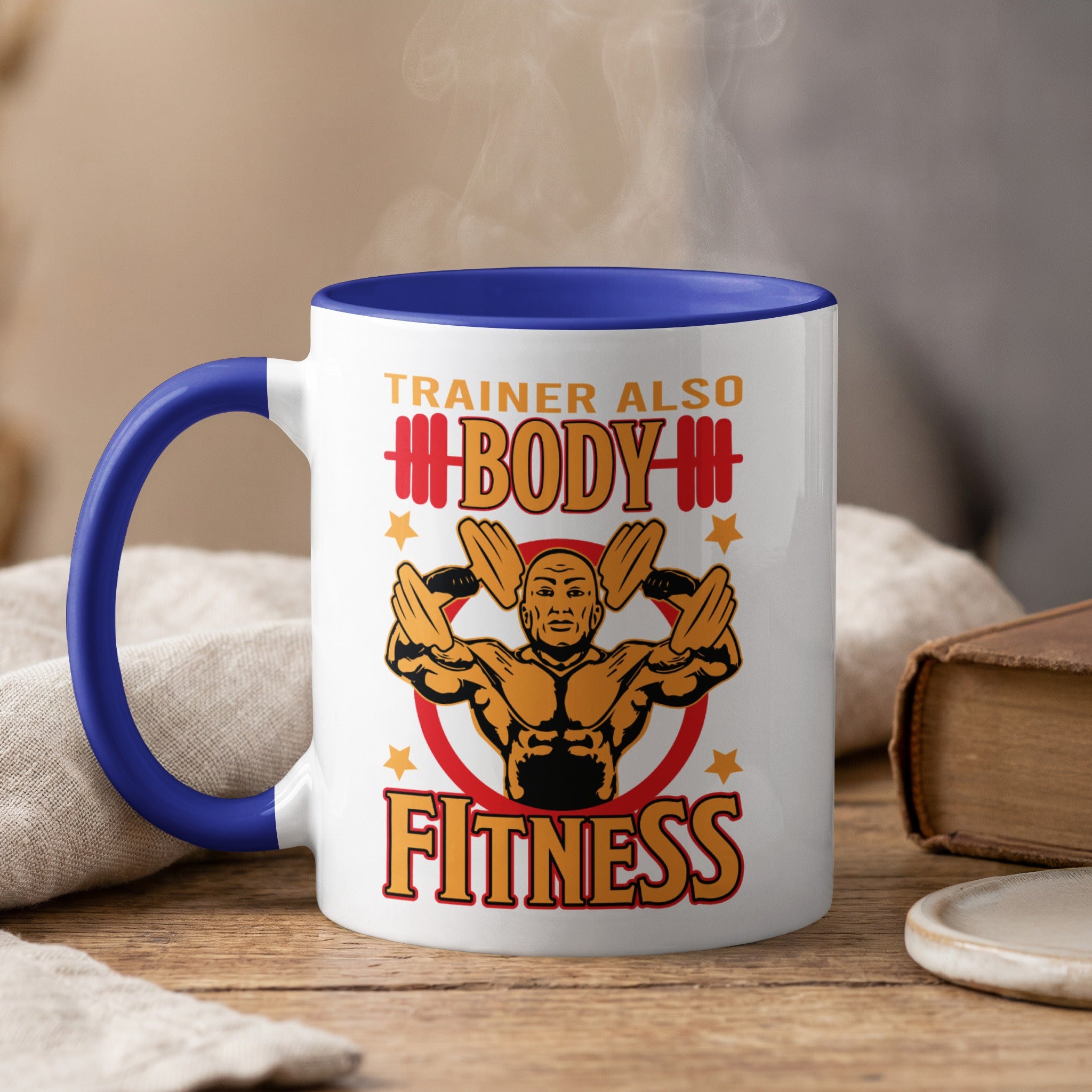 White mug with blue rim, featuring "Trainer Also Body Fitness" and muscular graphic.