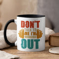 White mug with black rim and handle, featuring text "Don't talk to me I'm working out".