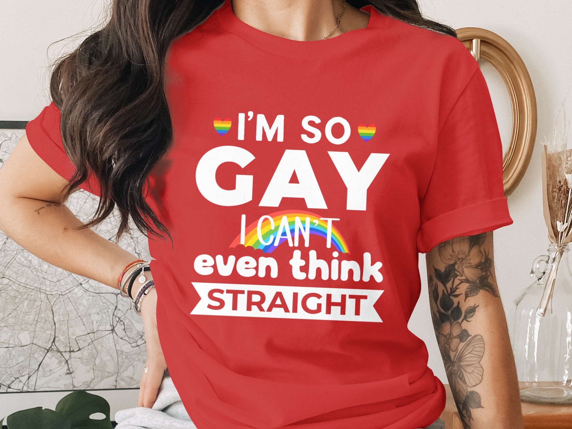Red t-shirt with "I'm so GAY I can't even think STRAIGHT" text and rainbow hearts.