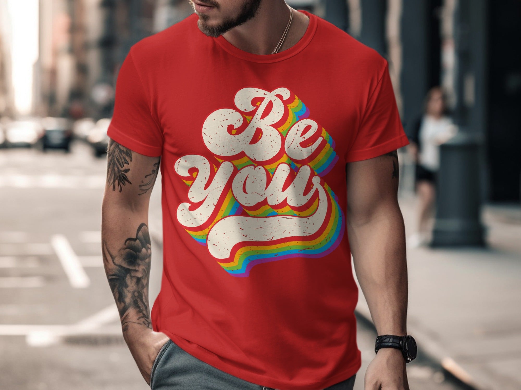 Red t-shirt with white distressed "Be You" text in rainbow stripes.