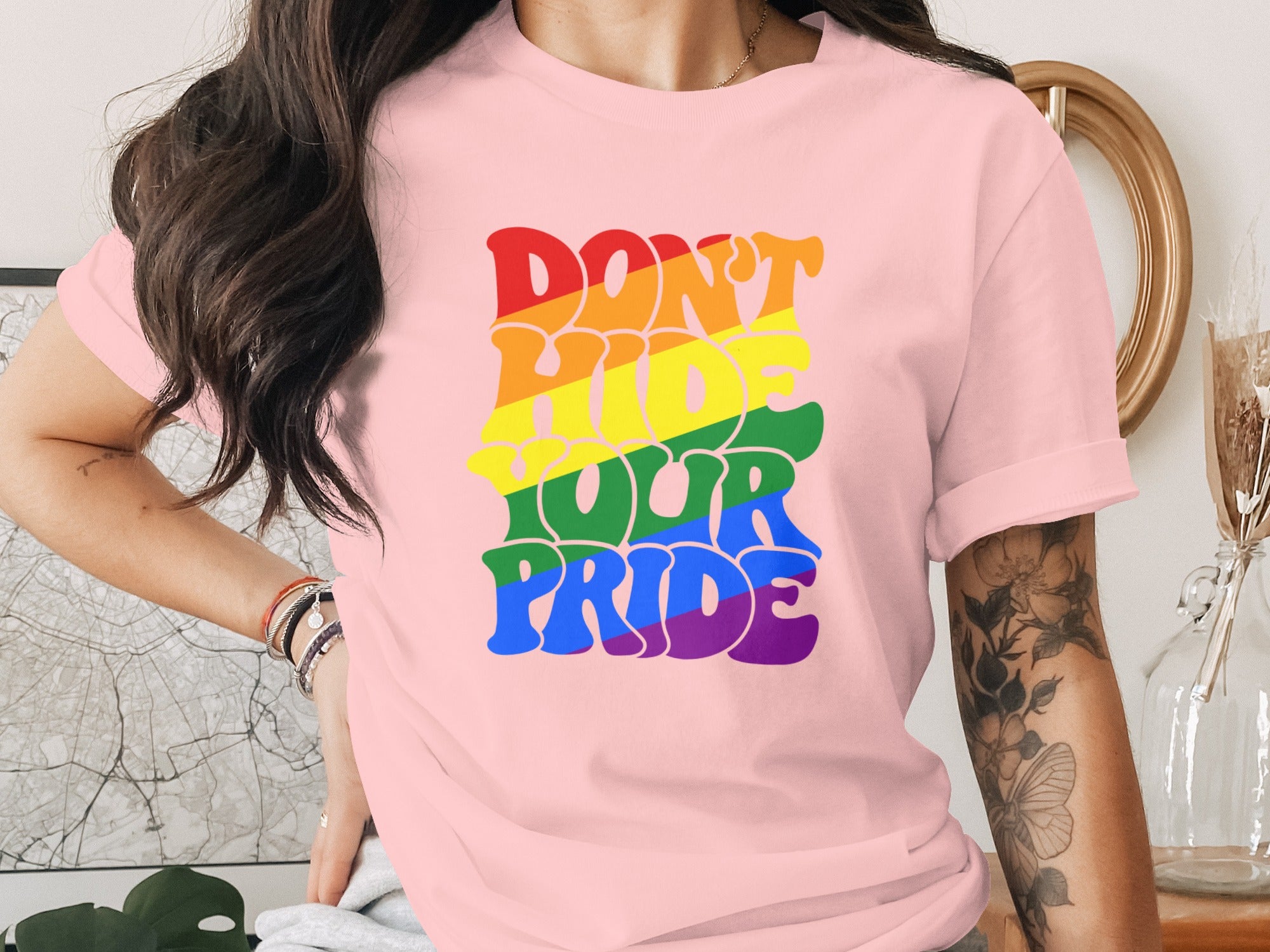 Pink t-shirt with "DON'T HIDE YOUR PRIDE" text in rainbow colors.