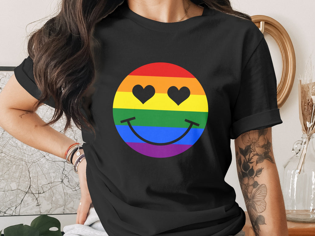 Black t-shirt with rainbow smiley face featuring heart eyes and stripes.