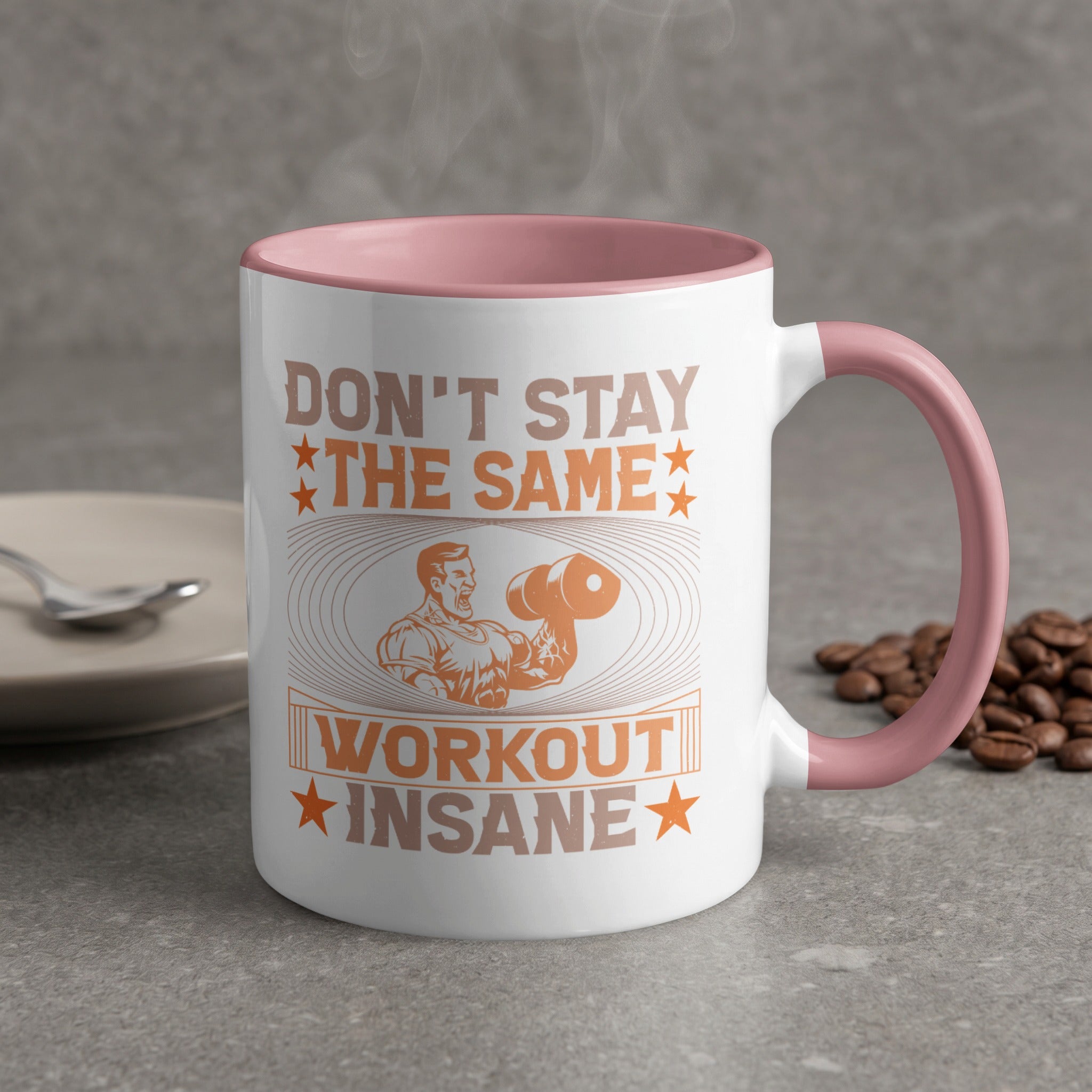 White mug with pink handle, featuring "DON'T STAY THE SAME WORKOUT INSANE" text and man lifting weights.