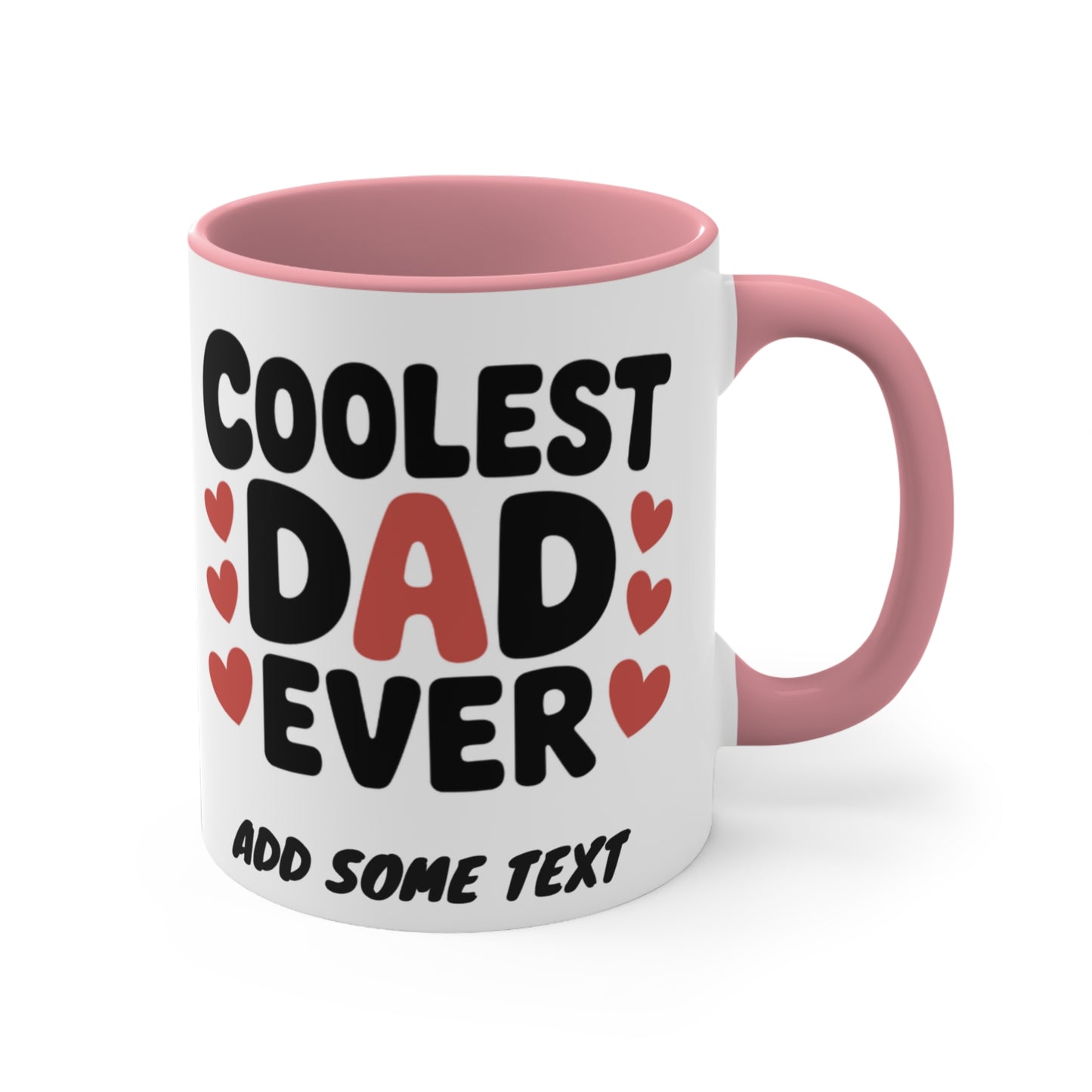 White mug with pink handle, text "Coolest Dad Ever" and heart accents.