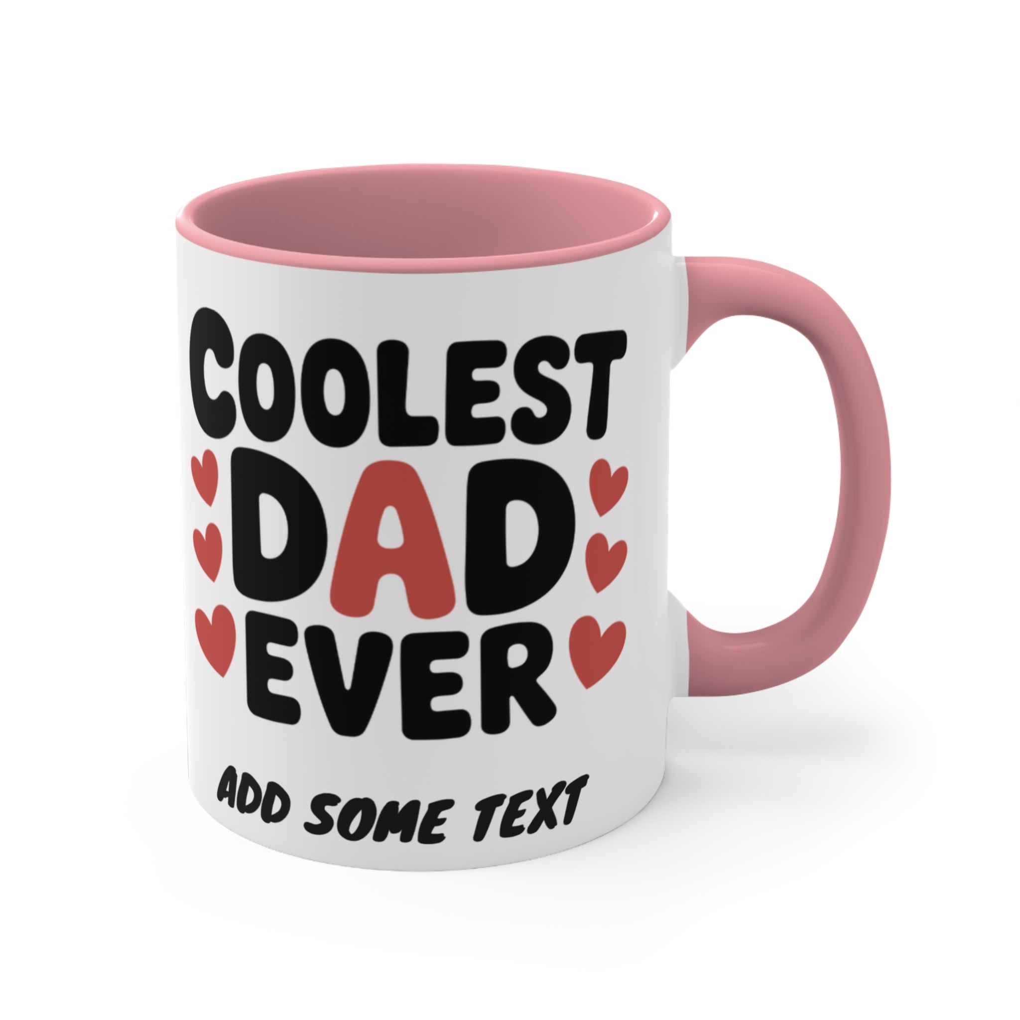 White mug with pink handle, text "Coolest Dad Ever" and heart accents.