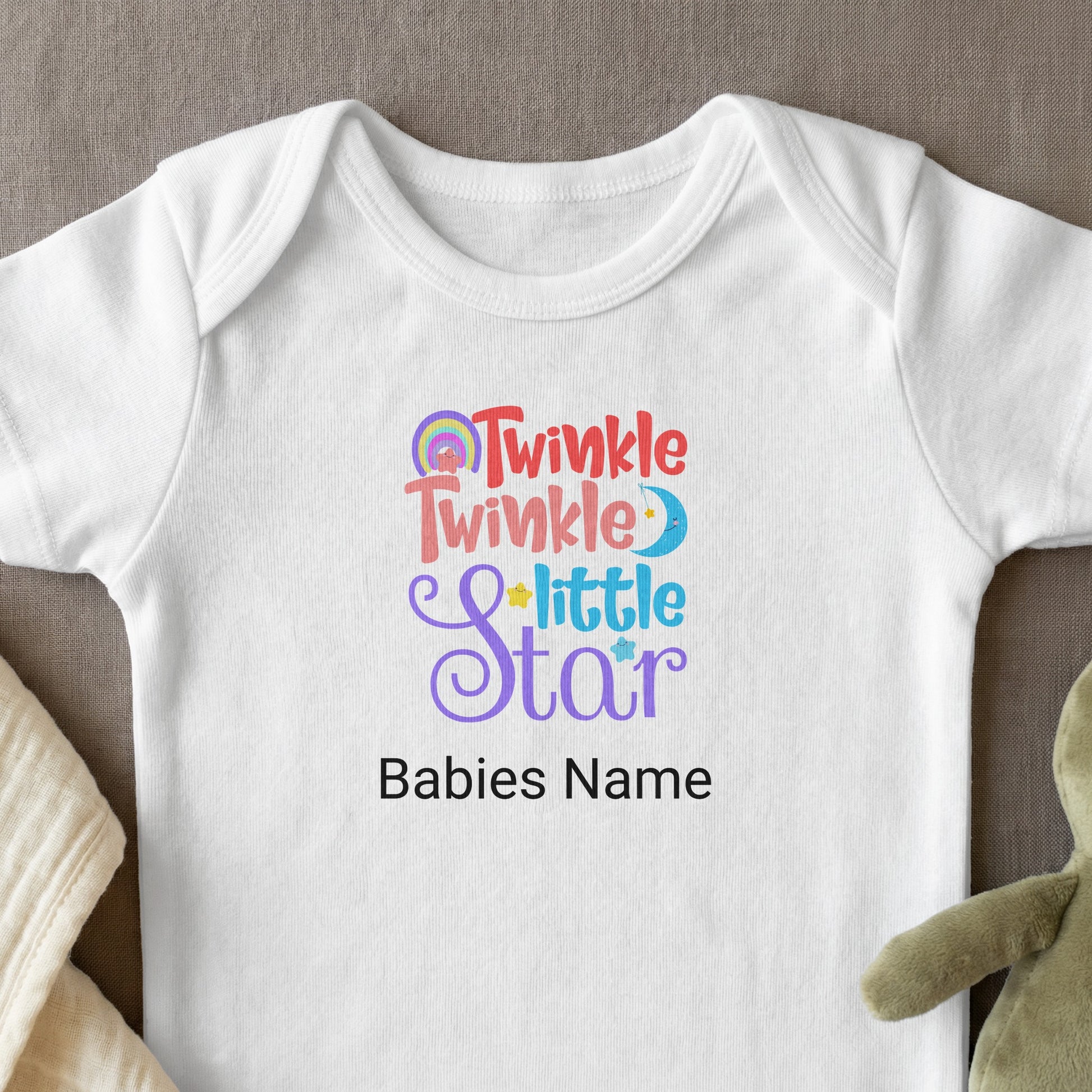 White baby onesie with "Twinkle Little Star" and "Babies Name" text.