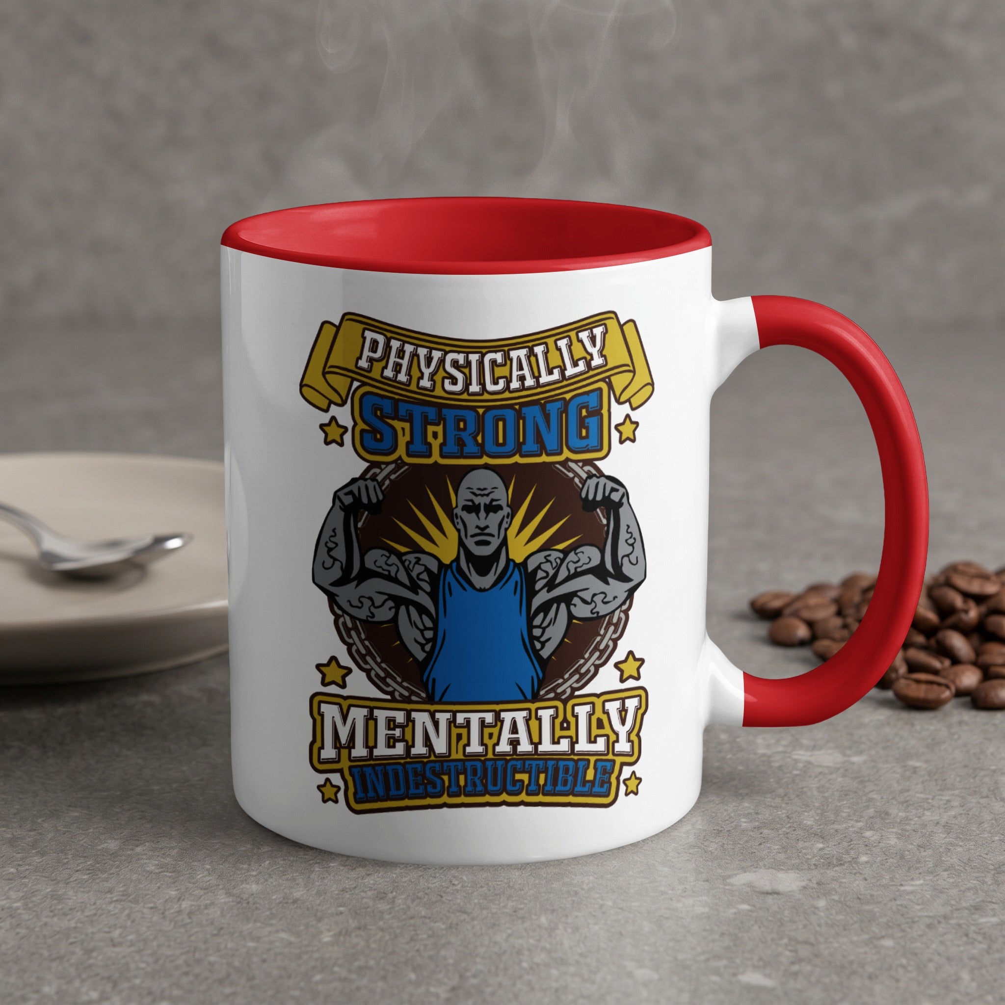 White mug with red handle, "Physically Strong Mentally Indestructible" text and muscular man graphic.