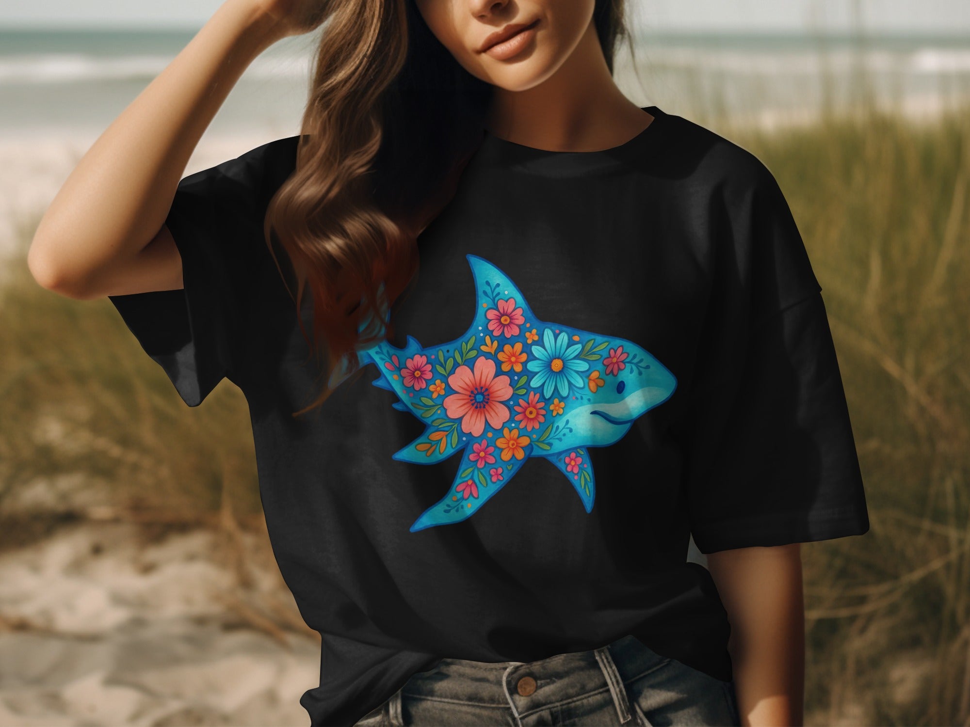 Black t-shirt with a blue shark graphic decorated with colorful flowers.