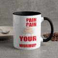 White mug with black rim, "Pain Gain Your Warmup" text, and muscular figure.