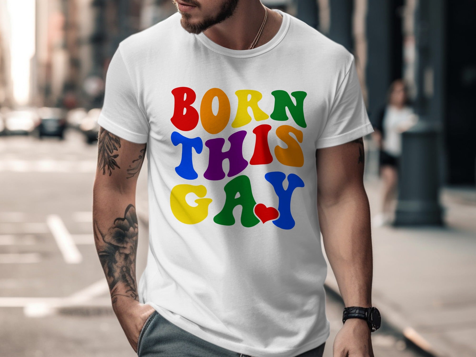 White t-shirt with rainbow text "BORN THIS GAY" and a red heart.