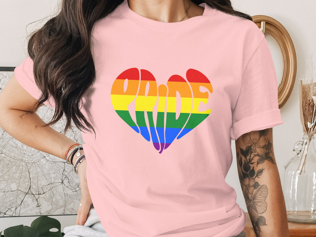 Pink t-shirt with rainbow heart graphic that reads "Pride".