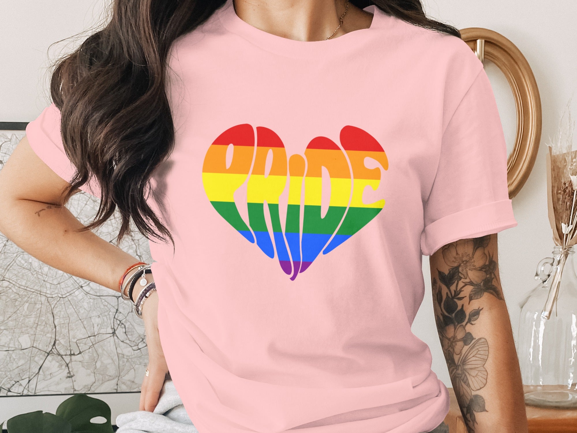 Pink t-shirt with rainbow heart graphic that reads "Pride".