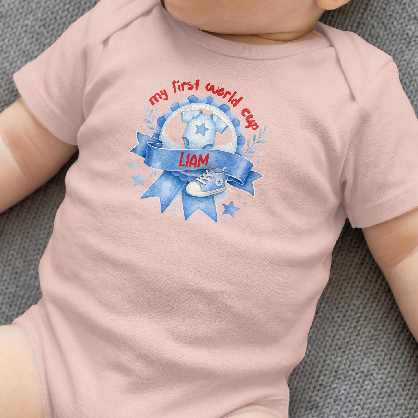 Baby onesie with "my first world cup" text and a baby shoe graphic.