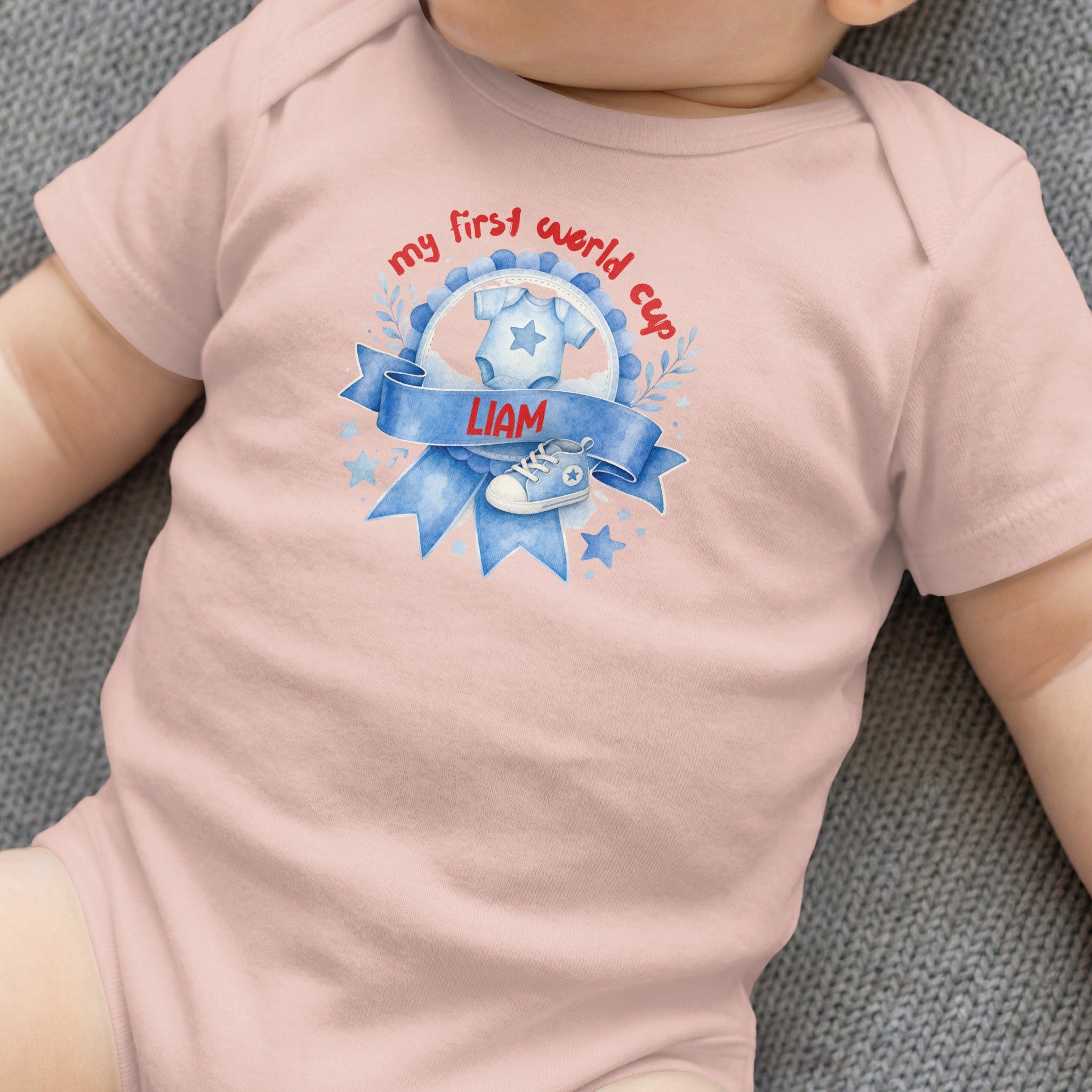 Baby onesie with "my first world cup" text and a baby shoe graphic.