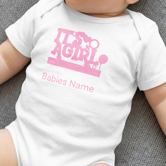 White baby onesie with "It's a girl" text and placeholder for baby's name.