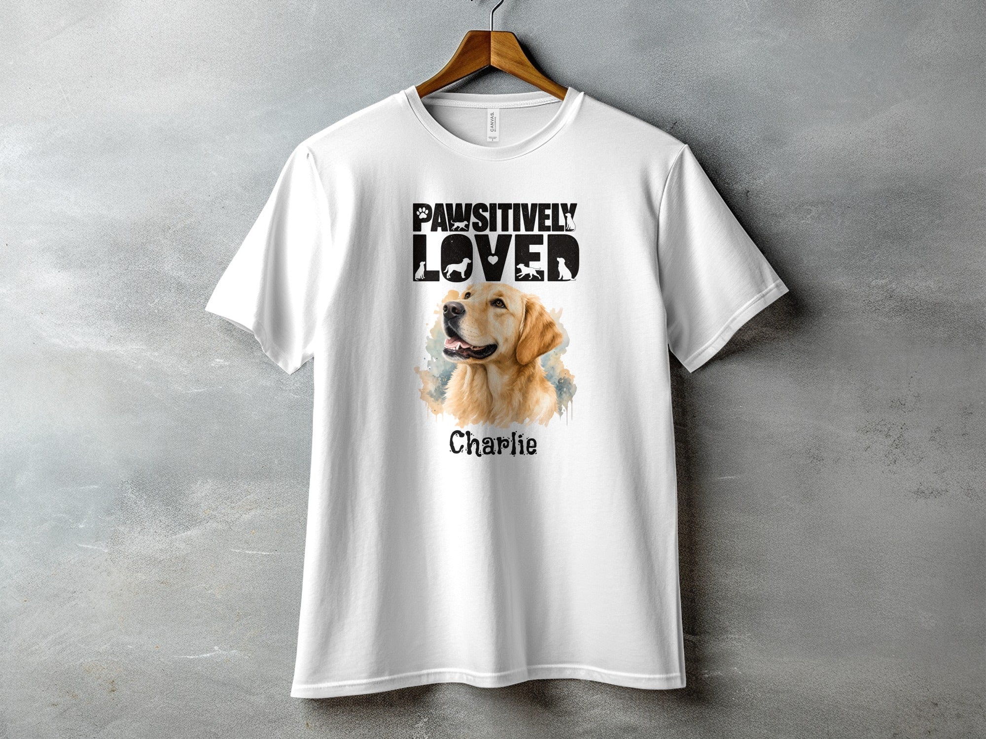 White t-shirt featuring a Golden Retriever portrait with "Pawsitively Loved" text and "Charlie".