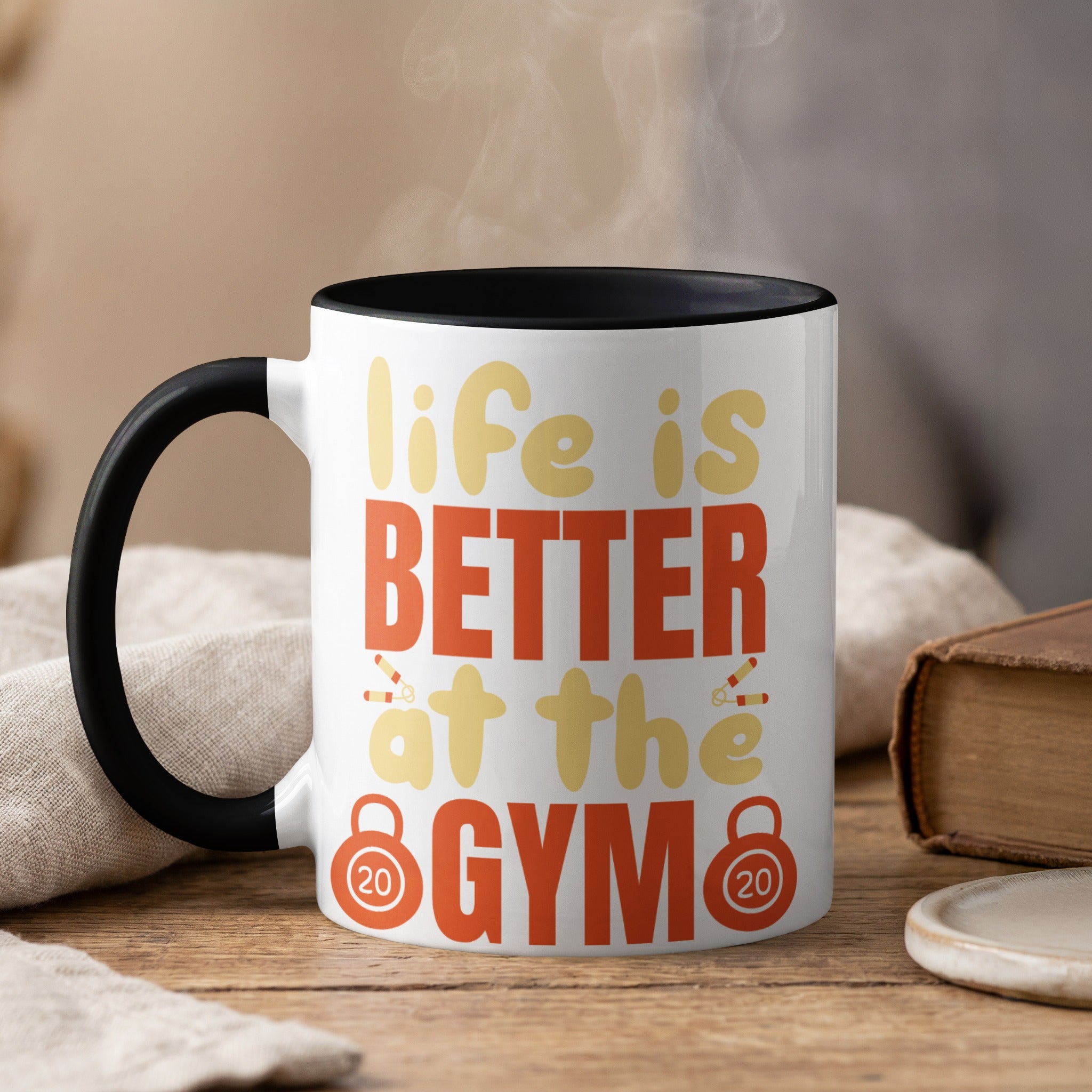 White mug with black rim, saying "Life is BETTER at the GYM".