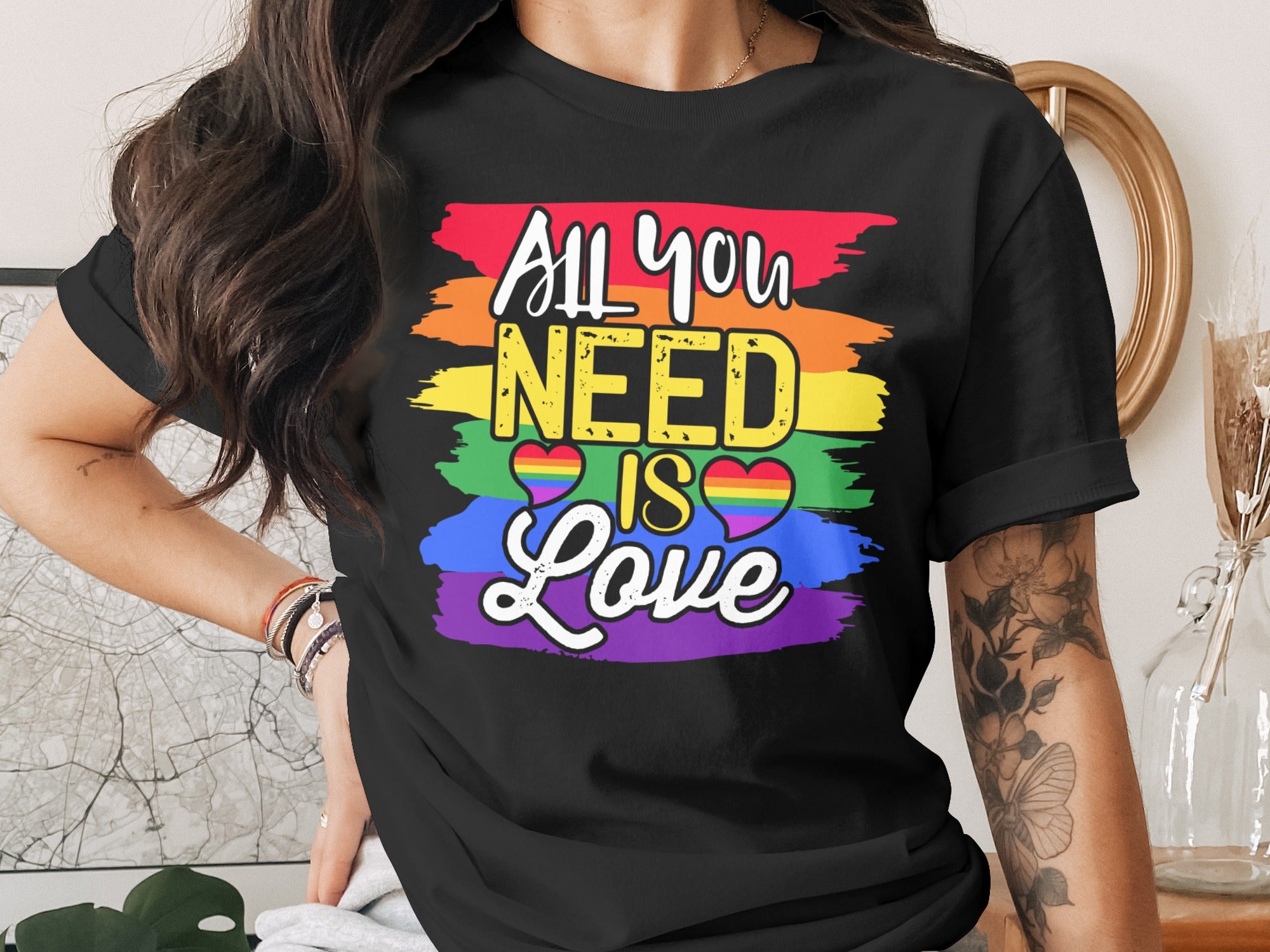 Black t-shirt with rainbow stripes and text "All you NEED IS Love".