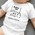 White baby onesie with "Relax my Mom is a Nurse" and stethoscope graphic.