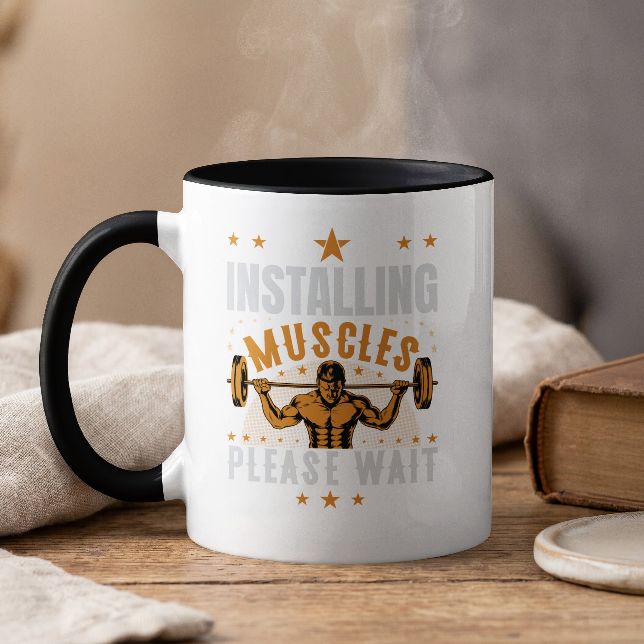 White mug with black rim, "Installing Muscles Please Wait" and barbell graphic.