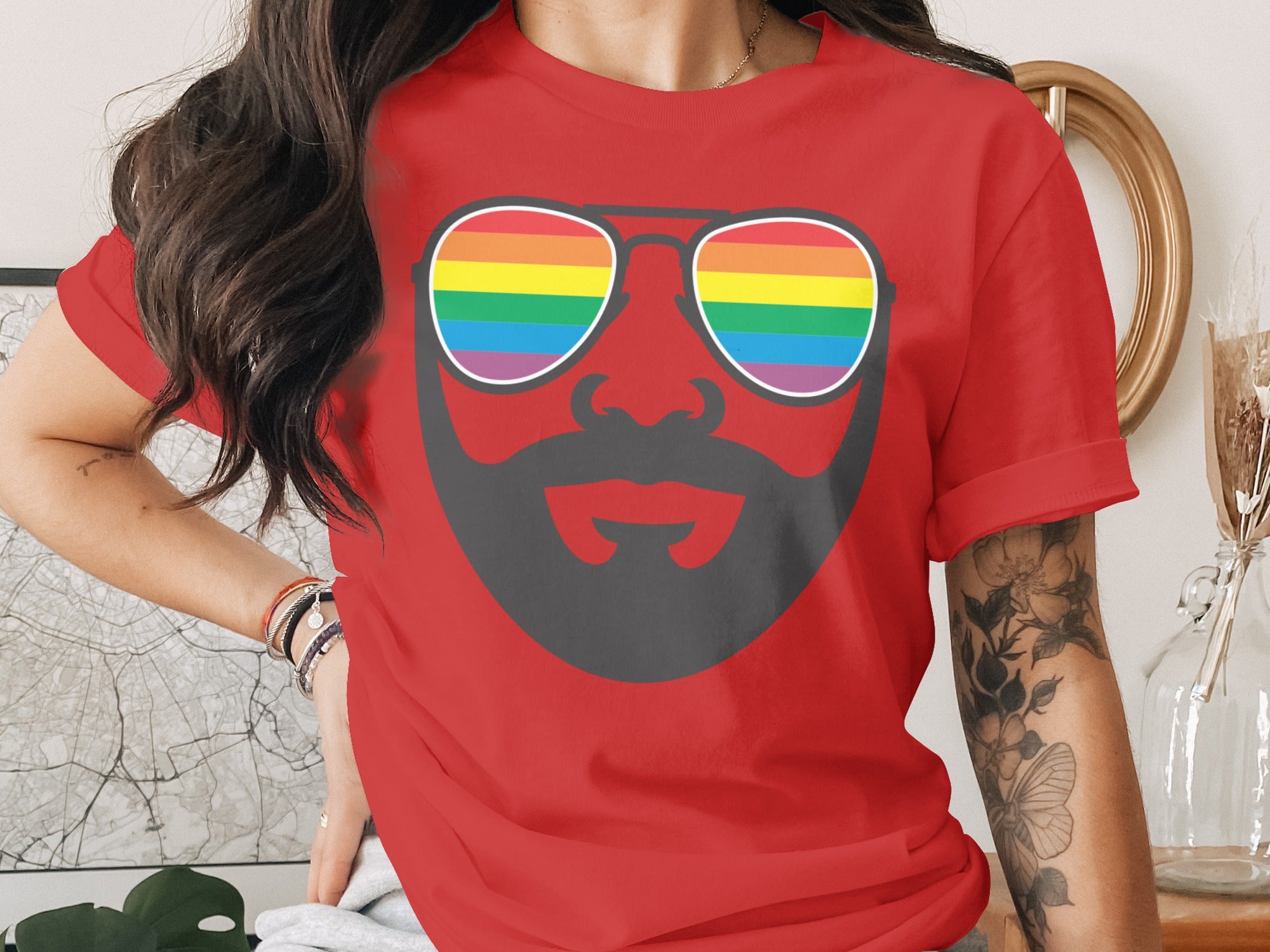 Red t-shirt with a graphic of sunglasses with rainbow lenses and a beard.