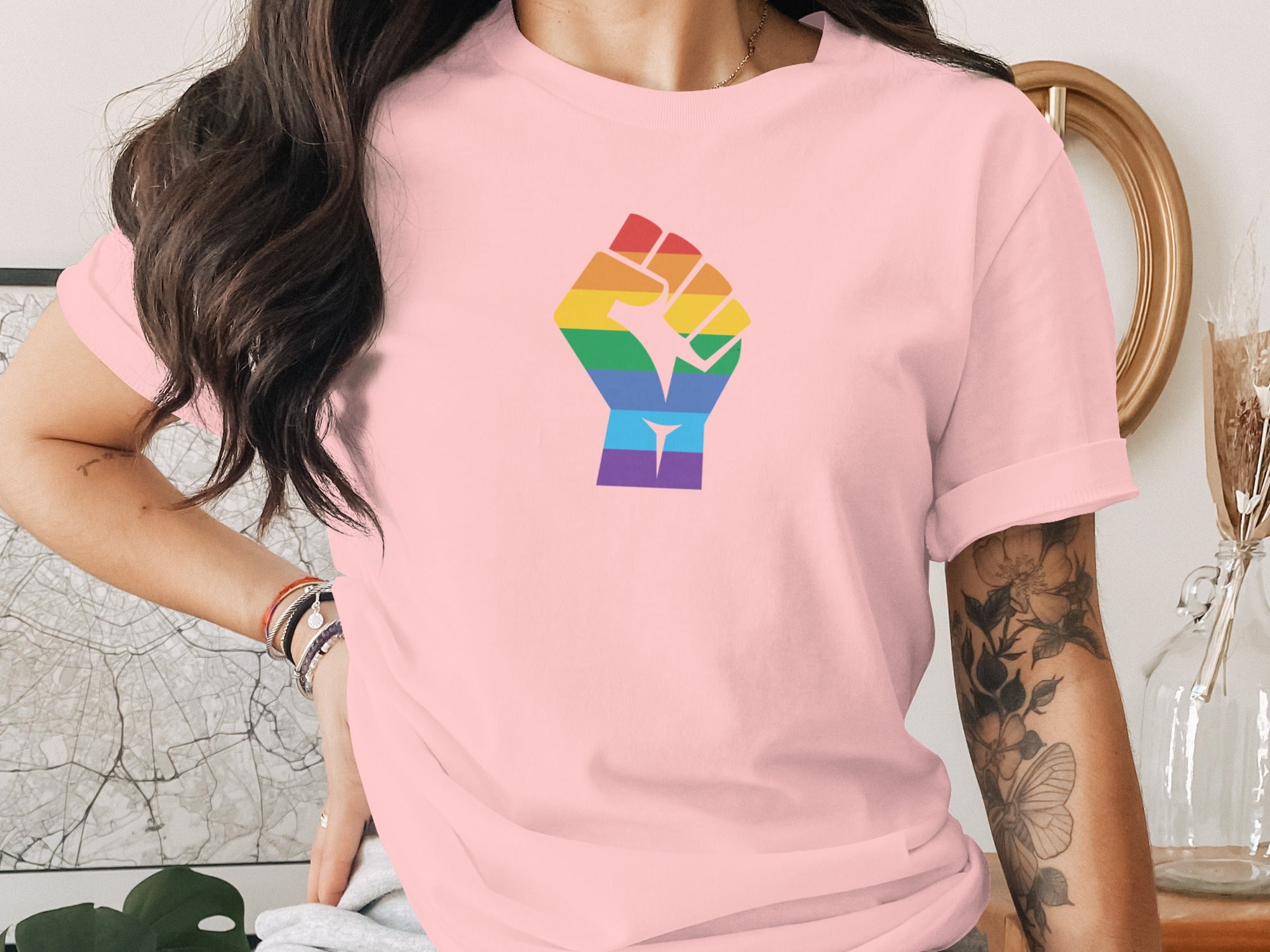 Pink t-shirt with rainbow fist graphic on chest
