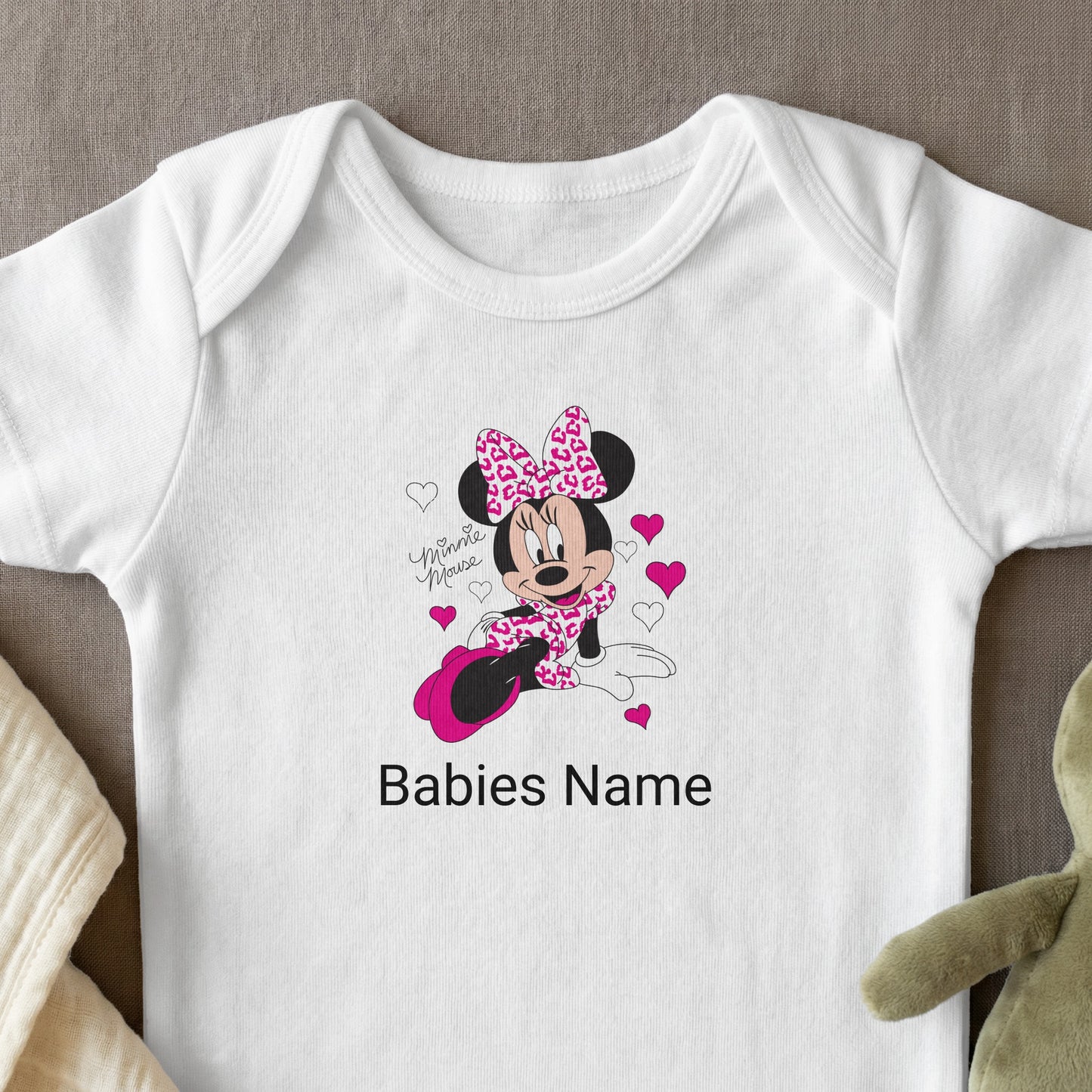White baby bodysuit with Minnie Mouse graphic and "Babies Name" placeholder.