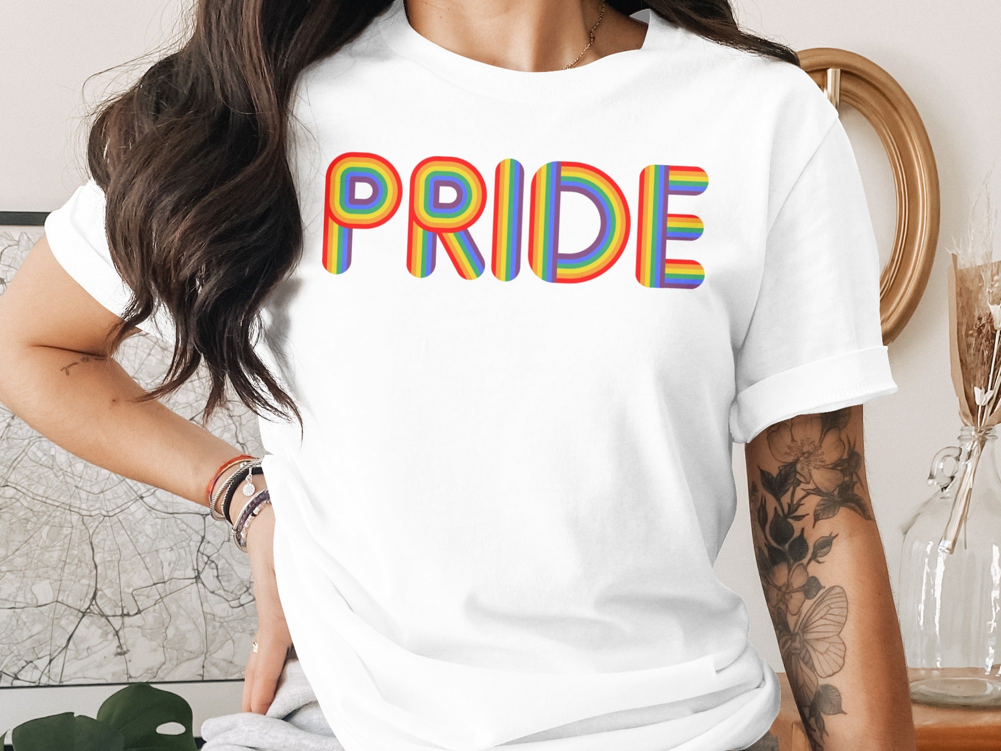 White t-shirt with "PRIDE" in colorful rainbow lettering.