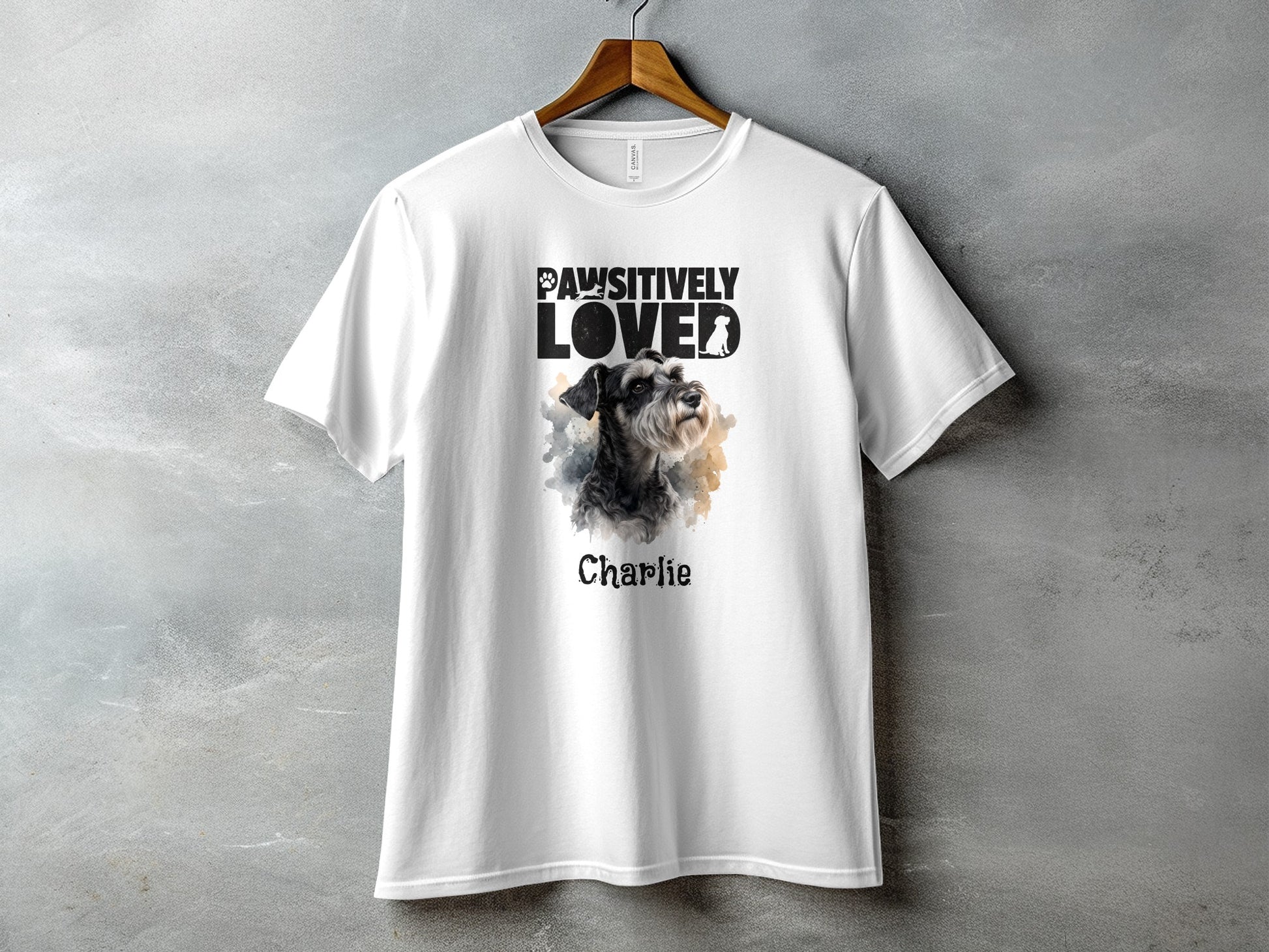 White t-shirt with "Pawsitively Loved" text and a schnauzer dog portrait named Charlie.