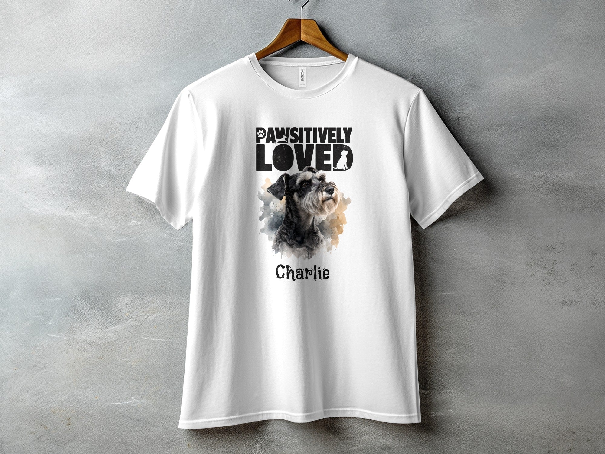 White t-shirt with "Pawsitively Loved" text and a schnauzer dog portrait named Charlie.