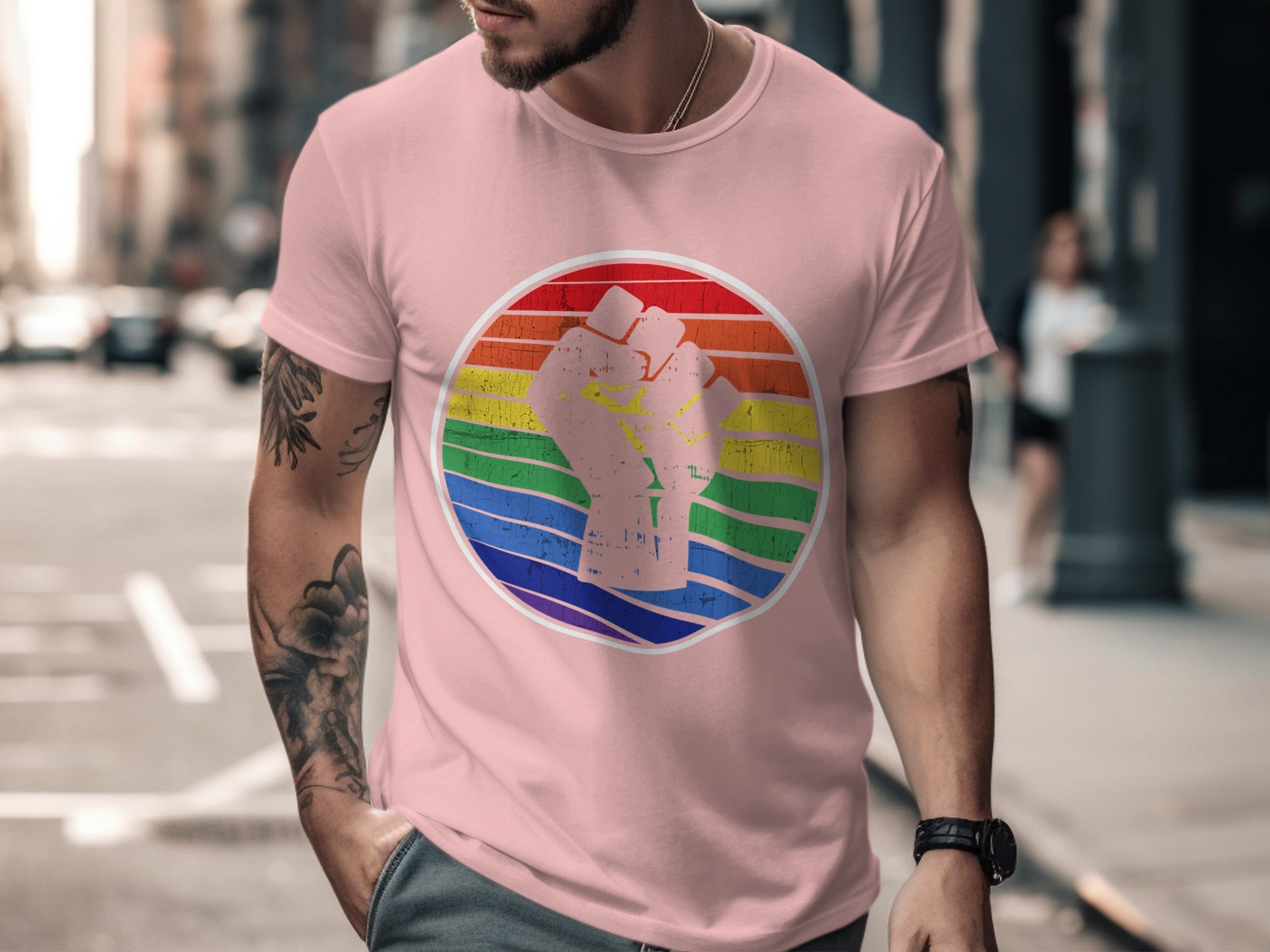 Pink t-shirt with a stylized raised fist on a rainbow background.