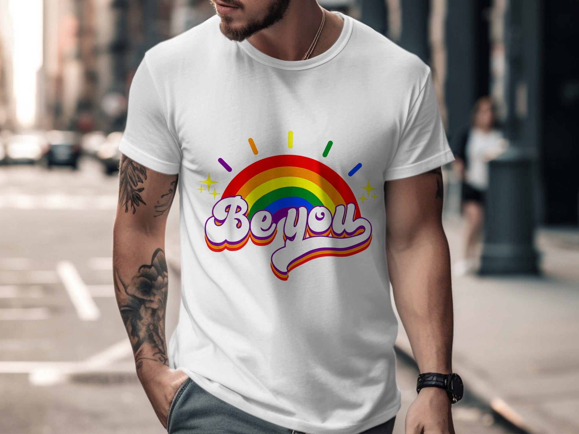 White t-shirt with rainbow "Be you" graphic and yellow stars.