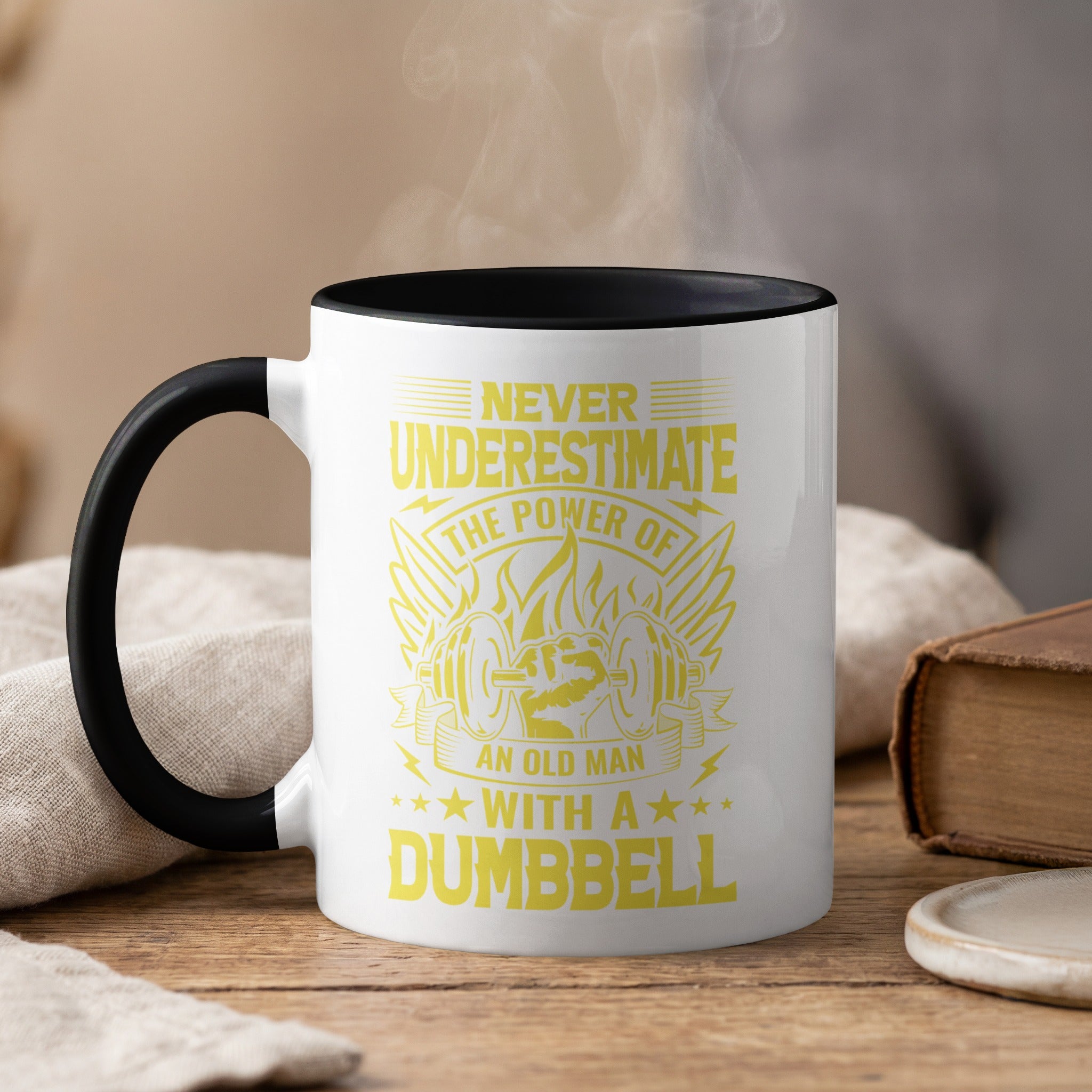 Yellow mug with "Never Underestimate the Power of an Old Man with a Dumbbell" text.