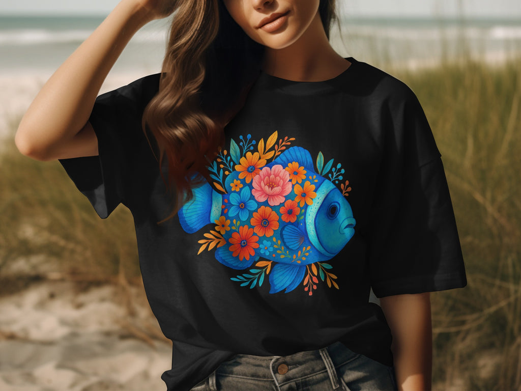 Black t-shirt with a blue fish design surrounded by colorful flowers and leaves.