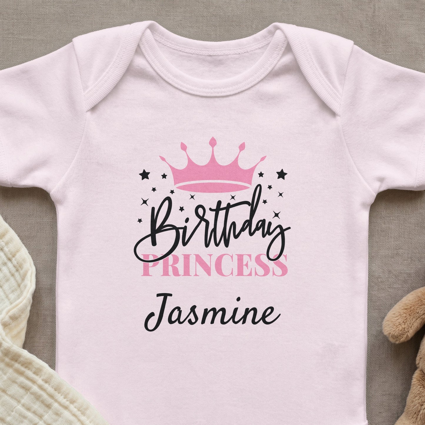 Pink baby onesie with "Birthday Princess Jasmine" and a crown design.