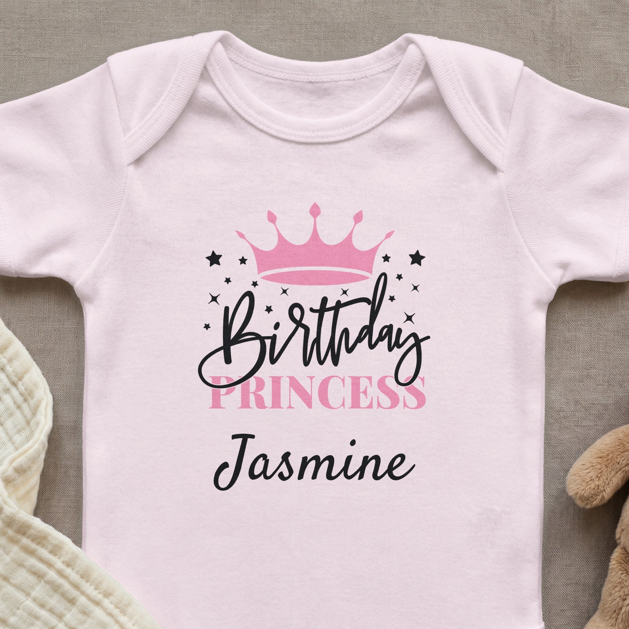 Pink baby onesie with "Birthday Princess Jasmine" and a crown design.