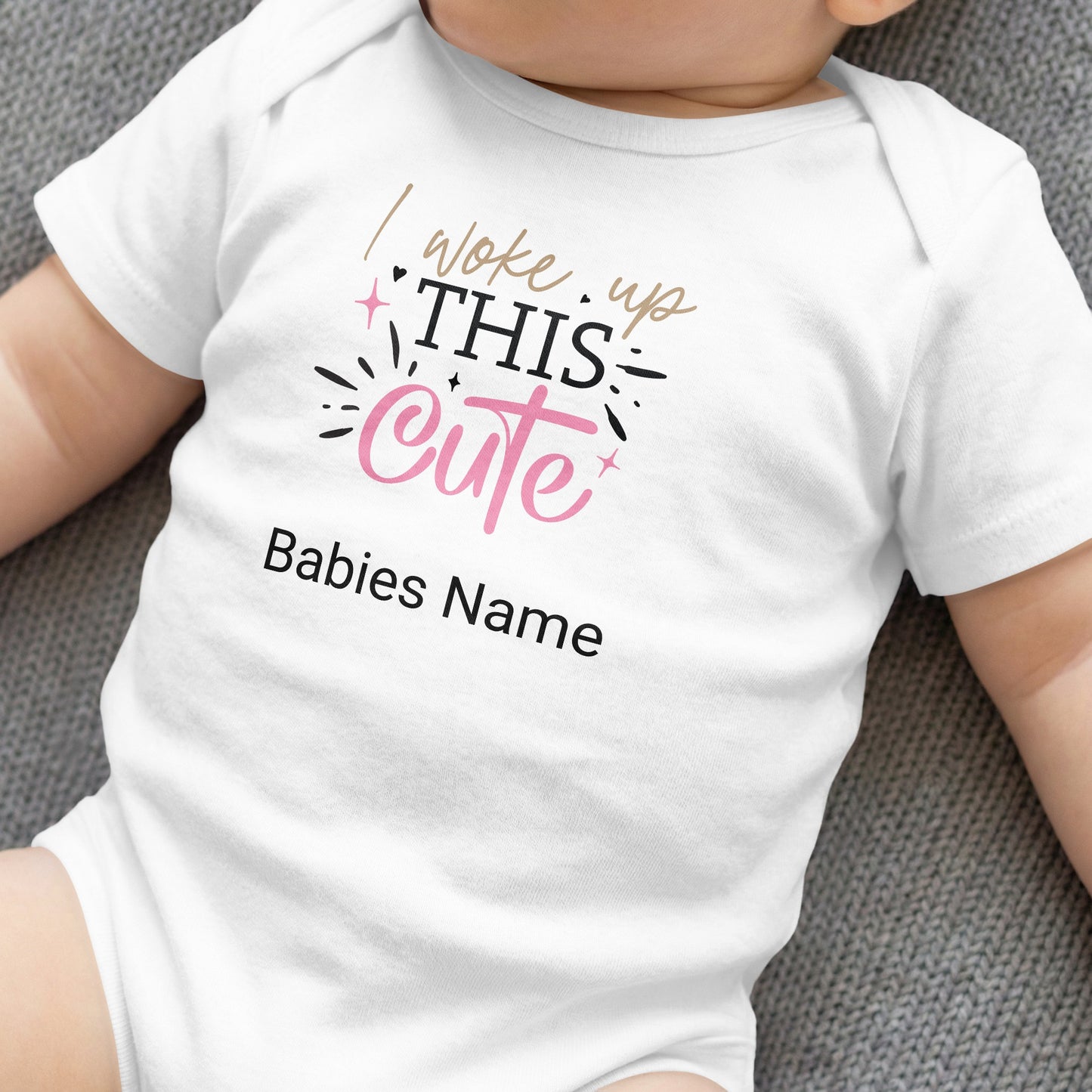 White baby bodysuit with "I woke up THIS cute" text and a blank space for name.