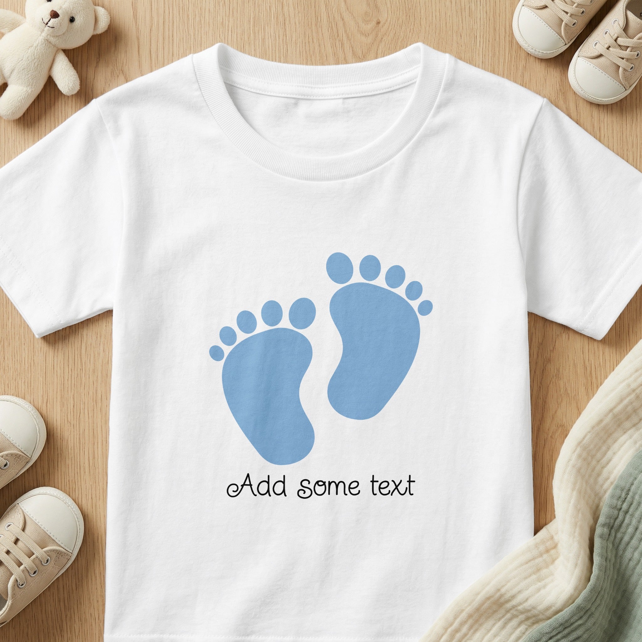 White t-shirt with blue baby footprints and text that reads "Add some text".