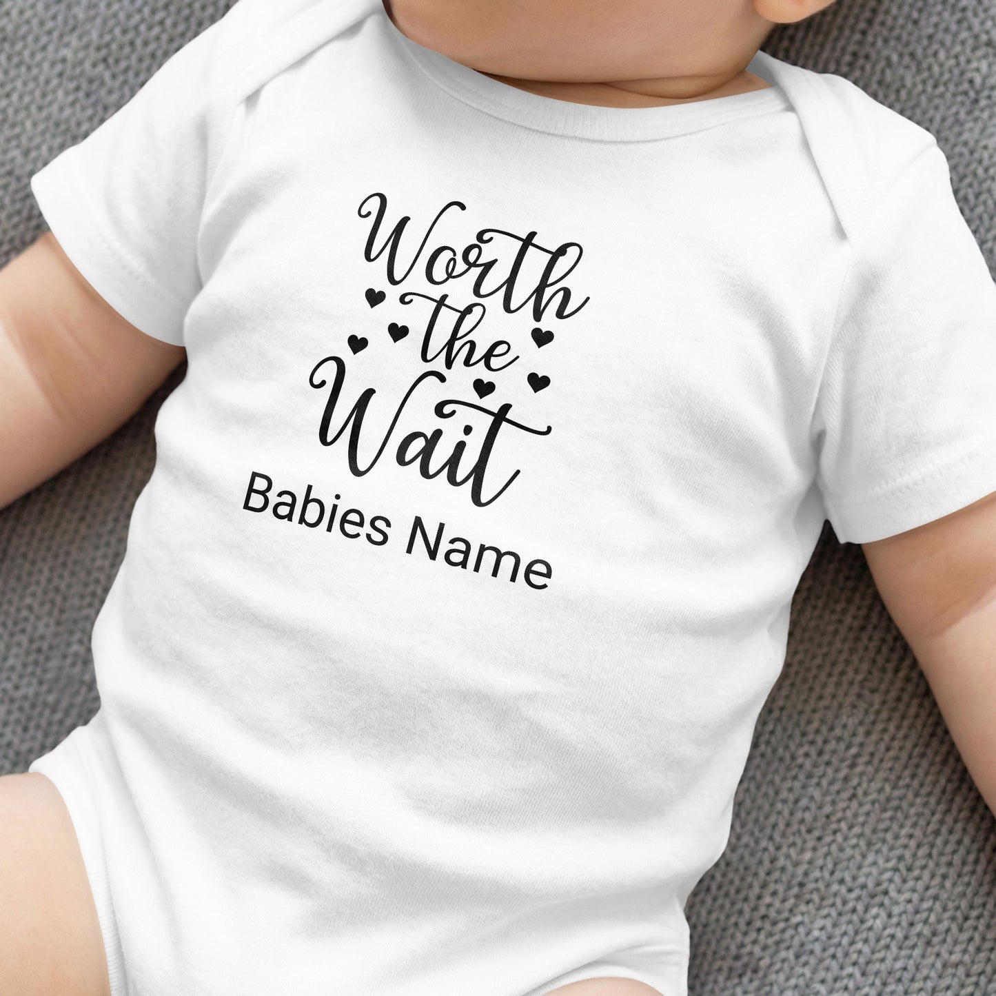White baby bodysuit with "Worth the Wait" and "Babies Name" text.