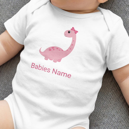 White baby onesie with a pink dinosaur and "Babies Name" text.