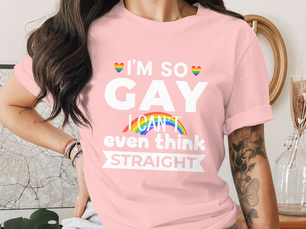 Pink t-shirt with "I'm so GAY I CAN't even think STRAIGHT" and rainbow accents.