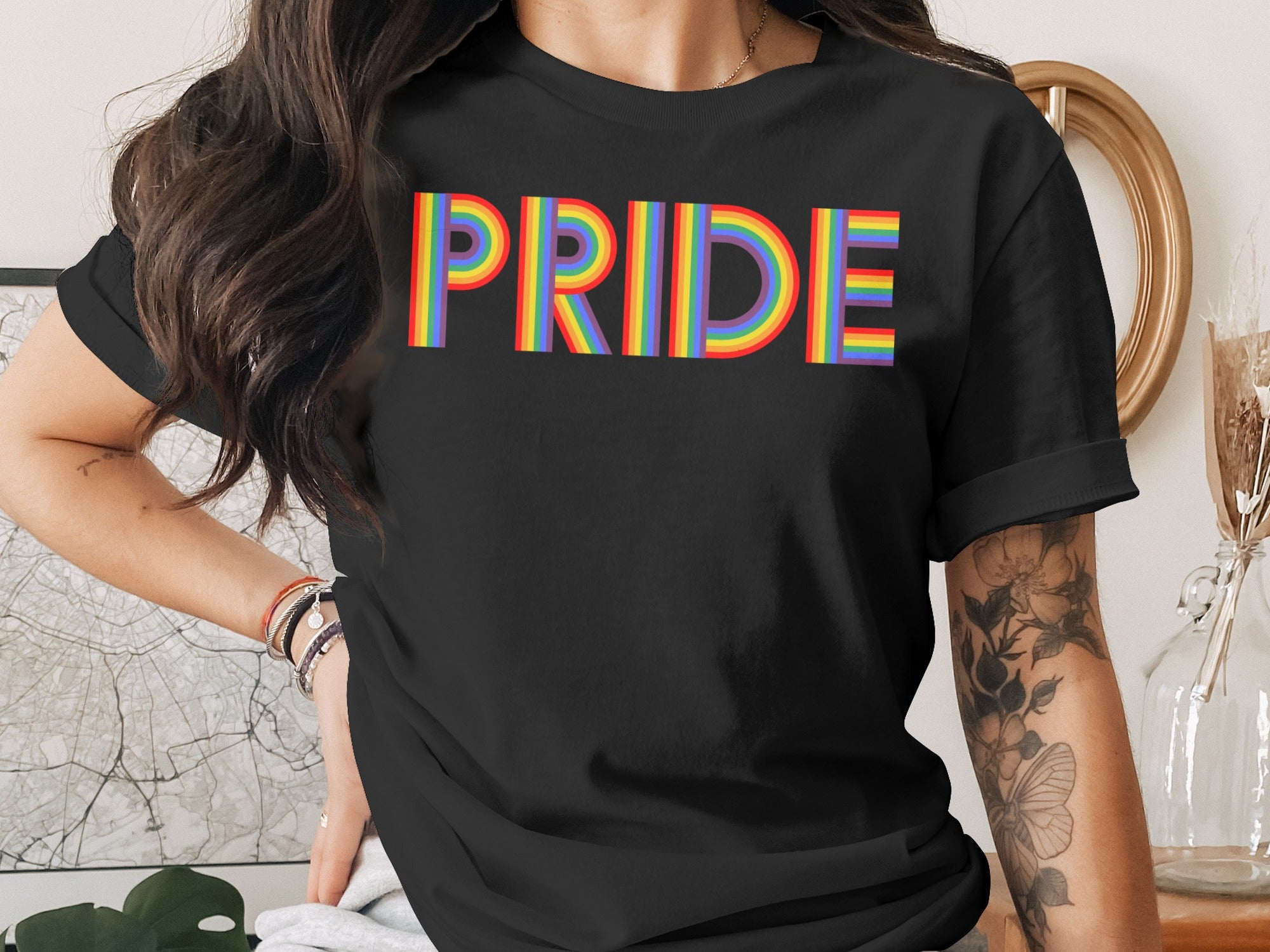 Black t-shirt with rainbow "PRIDE" text on the front.